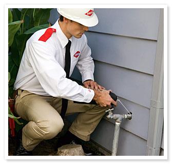 Orkin Man sealing plumbing gaps